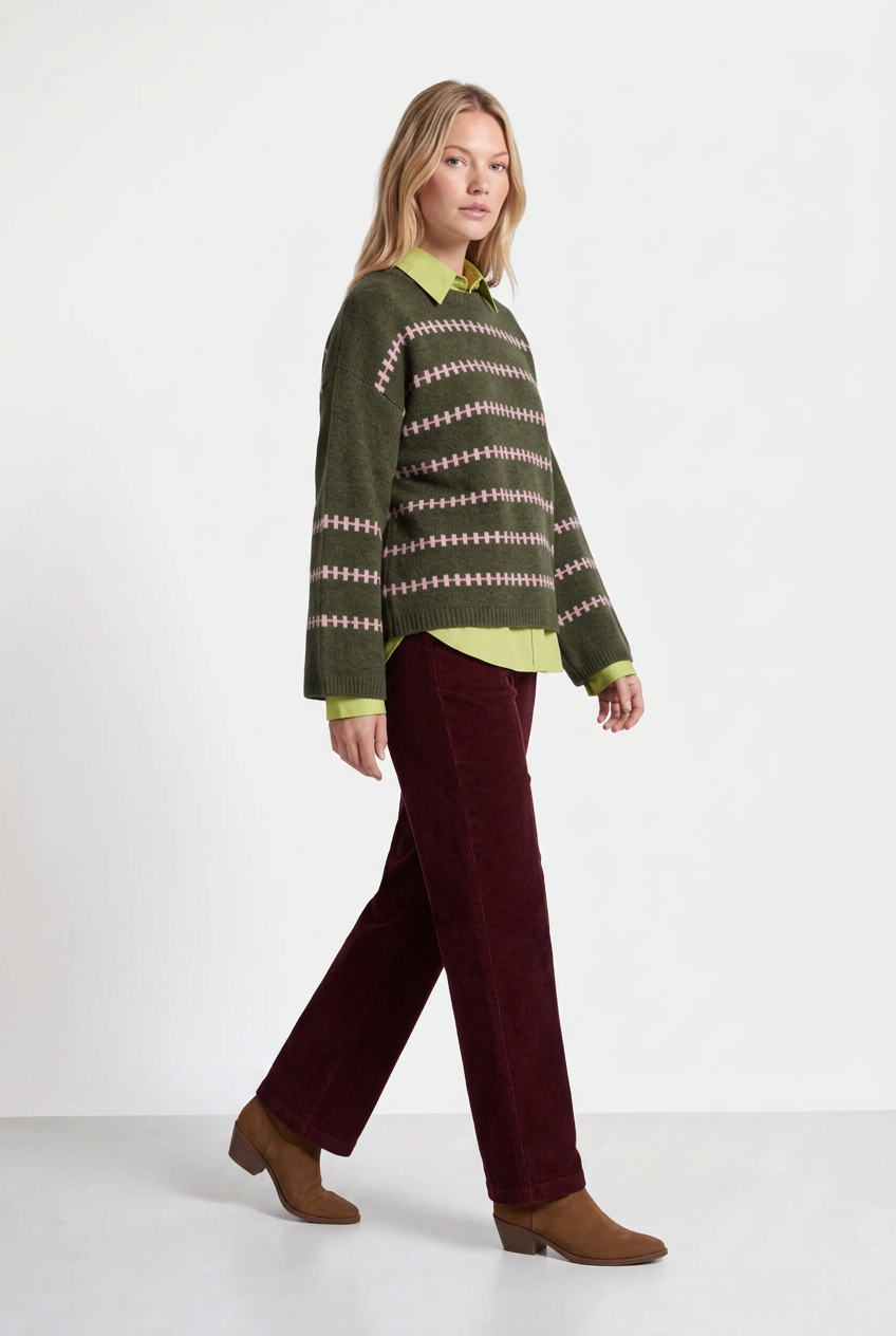 Three-quarter walking pose with green jumper, lime-green shirt and Bordeaux trousers
